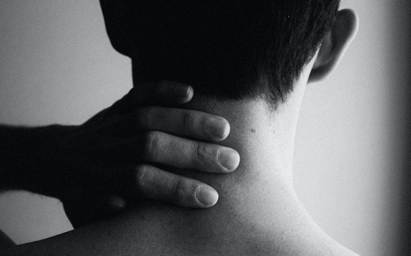 Парень чешет шею слева