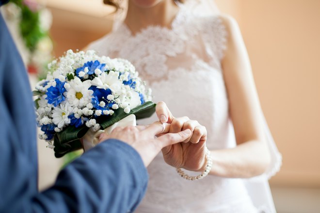 Невеста надевает кольцо жениху