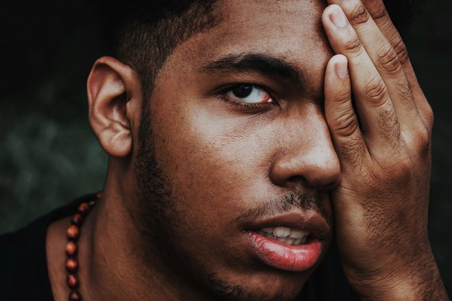 Парень прикрыл ладонью левый глаз